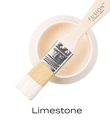 Open Fusion Mineral Paint container in Limestone, off-white brush, and “Limestone” color sample below.