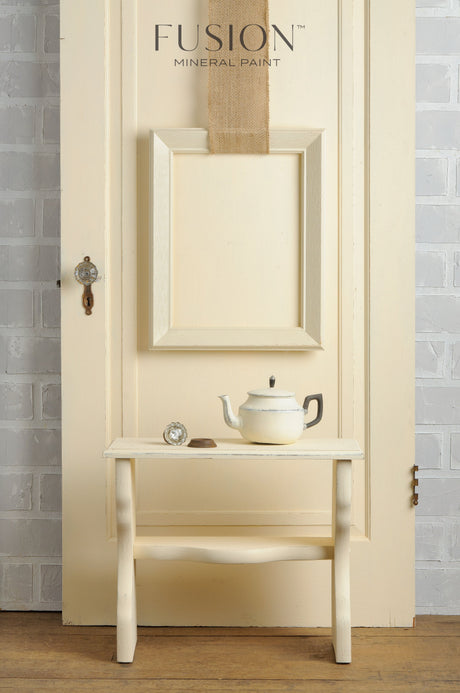 Limestone Fusion Mineral Paint teapot and teacup set by Fusion Mineral Paint on a bench near a cream door.