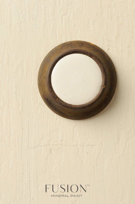 Round white ceramic doorbell with a weathered rim, finished in Limestone Fusion Mineral Paint.