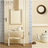 Cream teapot with matte finish on white bench, Limestone Fusion Mineral Paint wall in background.