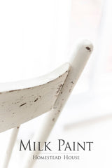 Distressed white chair finished with Homestead House Limestone Milk Paint; partial text visible below.