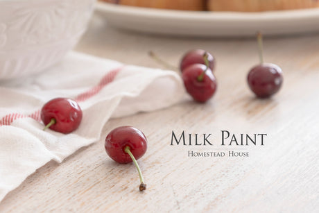 Four cherries on white wood and cloth finished with Limestone Milk Paint by Homestead House.