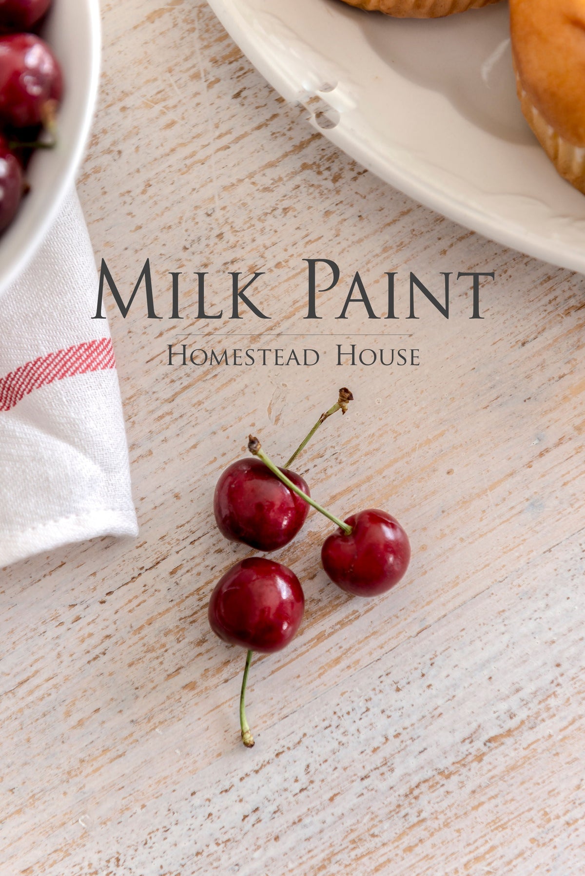 Three red cherries beside a plate and cloth, with text: Limestone Milk Paint by Homestead House.