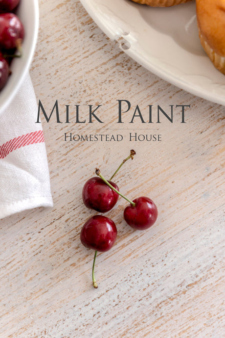 Three red cherries beside a plate and cloth, with text: Limestone Milk Paint by Homestead House.