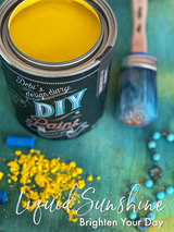 Open can of Liquid Sunshine DIY Paint with paintbrush and blue jewelry. Text: DIY Paint Co. Liquid Sunshine.