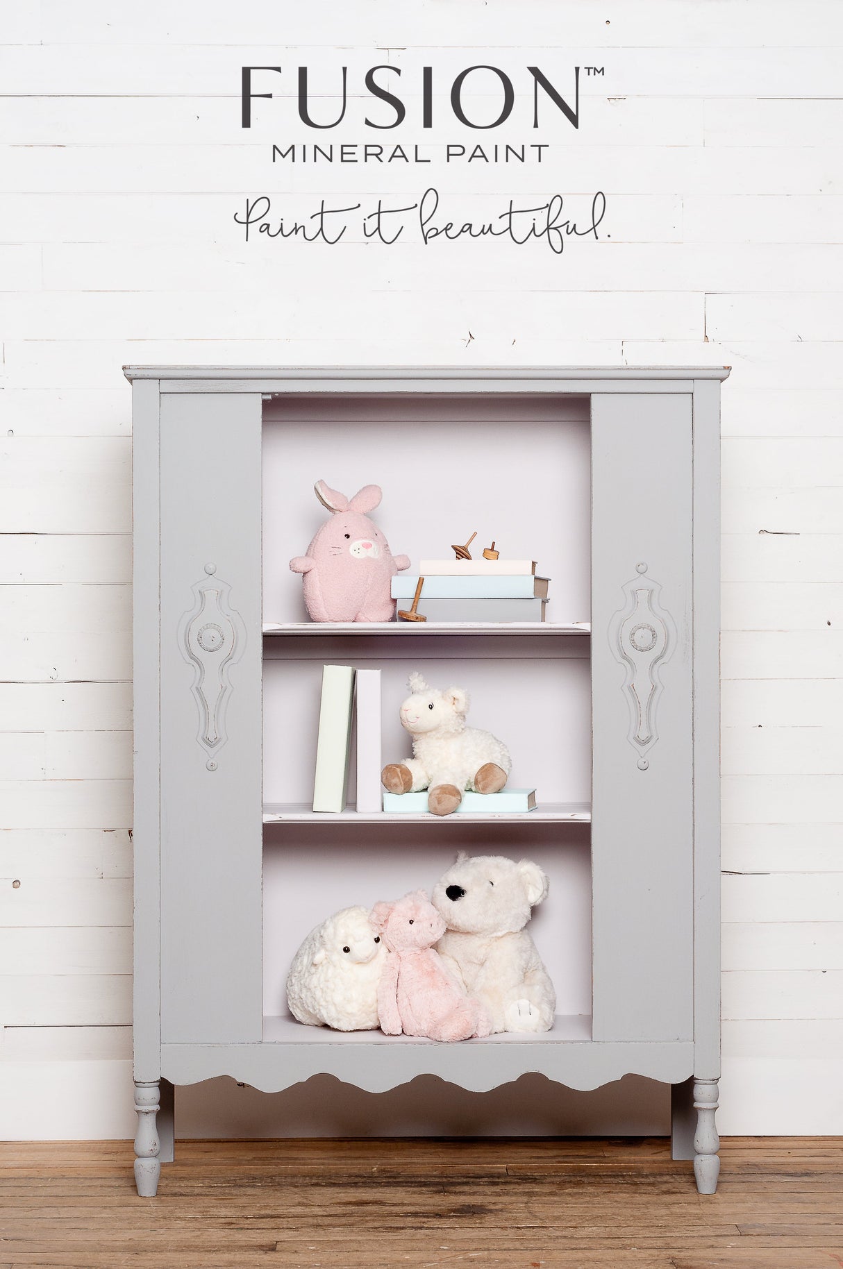 Gray matte cabinet with shelves, shown against a white wood wall in Fusion Mineral Paint’s Little Lamb shade.