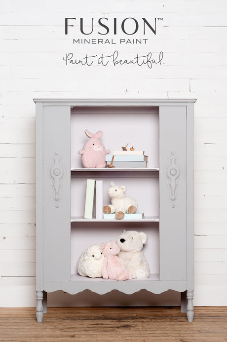 Gray matte cabinet with shelves, shown against a white wood wall in Fusion Mineral Paint’s Little Lamb shade.