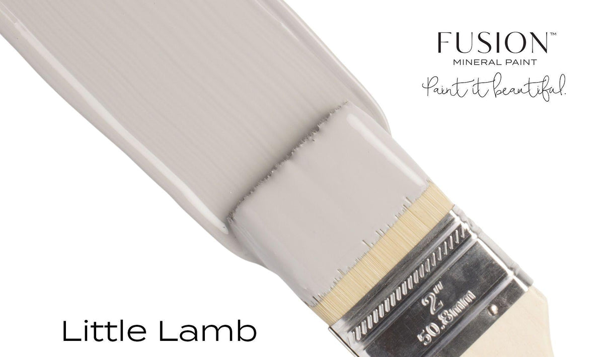 Paintbrush with Fusion Mineral Paint Little Lamb (off-white) on a white background.
