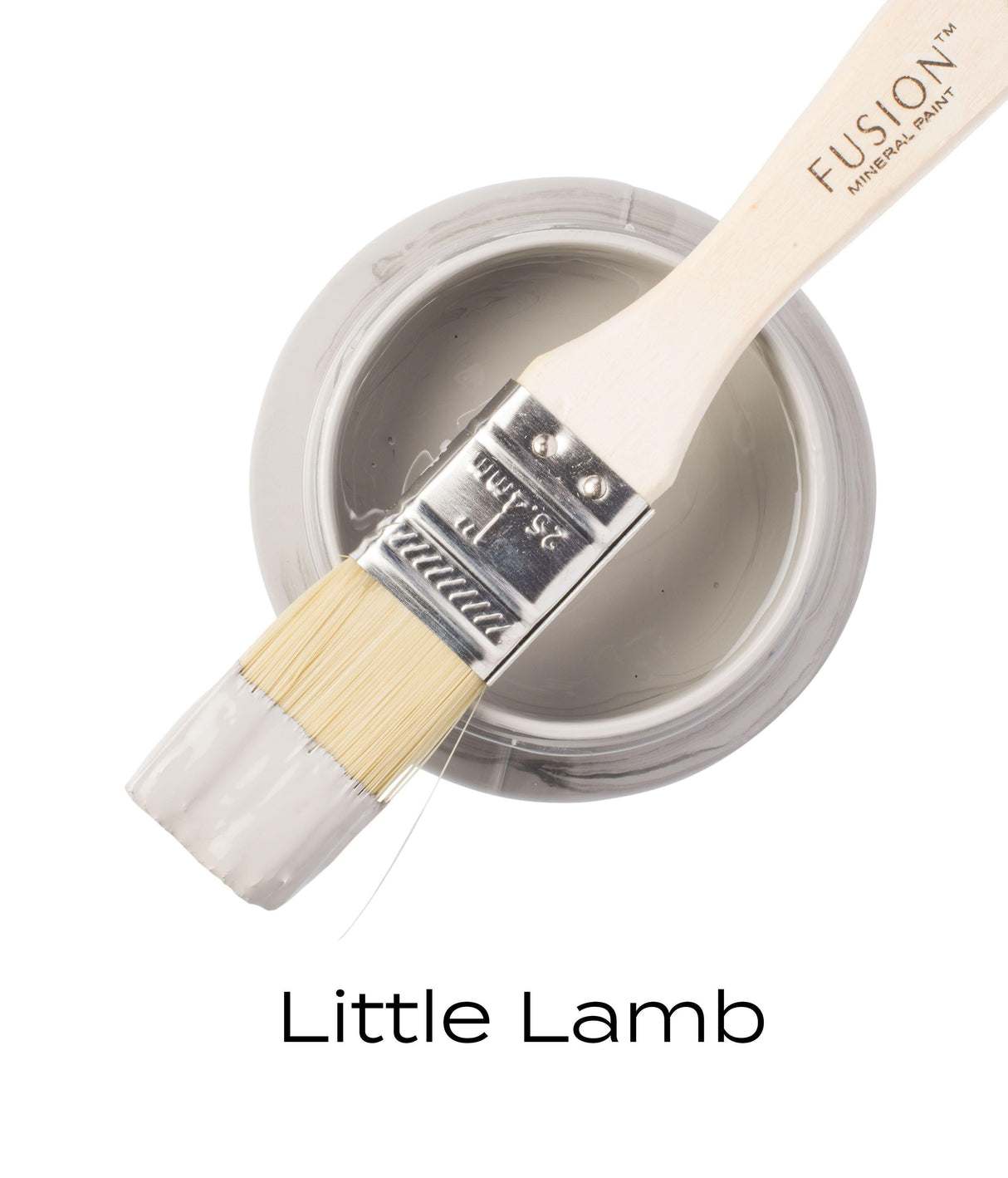 Brush with gray Little Lamb Fusion Mineral Paint resting on open jar labeled Little Lamb Fusion Mineral Paint.