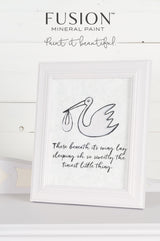 Little Stork Mineral Paint by Fusion, limited release, displayed on white shelf next to framed stork quote.