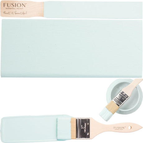 Brush, wood samples, and Little Teapot Fusion Mineral Paint (Seasonal) by Fusion on a plain background.