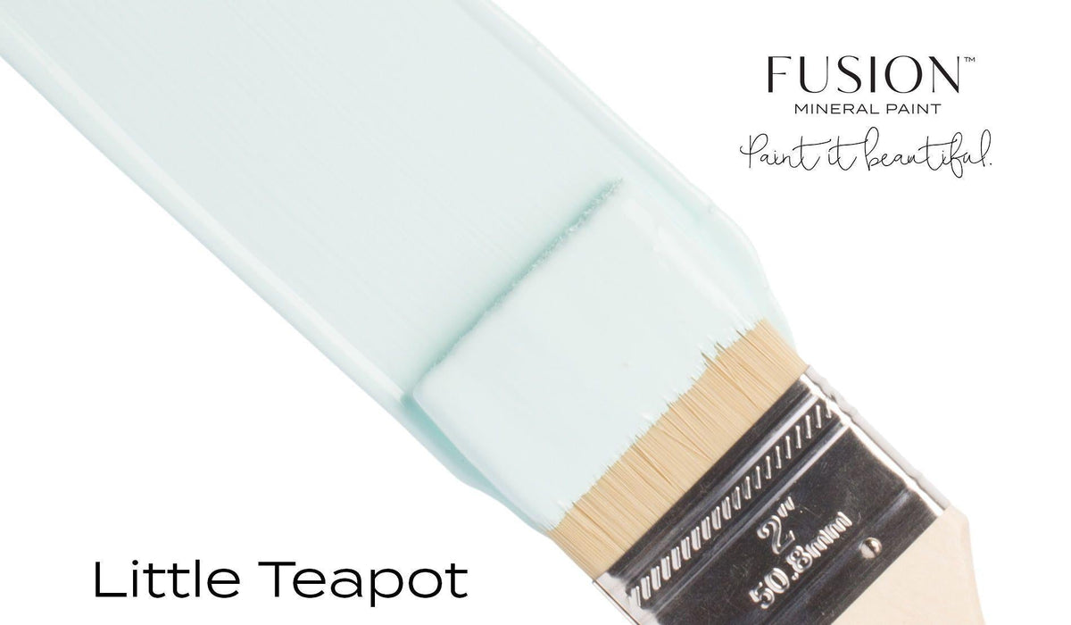 Brush with teal “Little Teapot Fusion Mineral Paint (Seasonal)” by Fusion Mineral Paint against a white background.