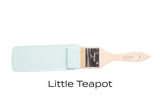 Paintbrush with teal bristles, labeled Little Teapot Fusion Mineral Paint by Fusion Mineral Paint below.