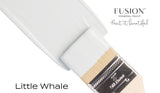 Paintbrush with blue paint next to a container labeled “Little Whale Fusion Mineral Paint” by Fusion Mineral Paint.