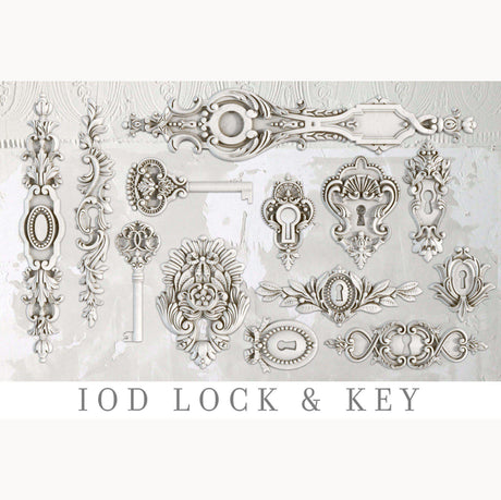 IOD Lock and Key Mould, ornate white and silver embellishments with I.O.D. logo on light background.