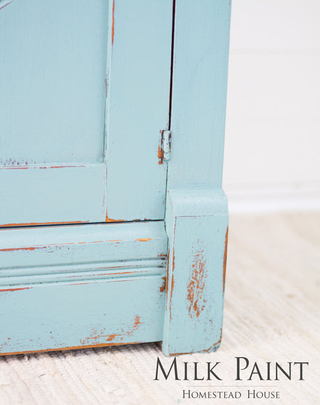 Distressed light blue cabinet, “Loyalist Milk Paint by Homestead House” text at bottom right.