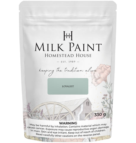 330g Homestead House Loyalist Milk Paint bag featuring floral and wagon artwork on the label.