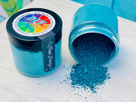 Spilled jar of Making Powder by DIY Paint Co. on light wood, with lid placed nearby.