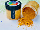 Two jars of DIY Paint Co. Making Powder, yellow; one closed, one open with powder spilling, Debi’s Design Diary line.