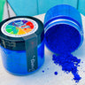 Two jars of DIY Paint Co. Making Powder; one is open with bright blue powder spilling out.