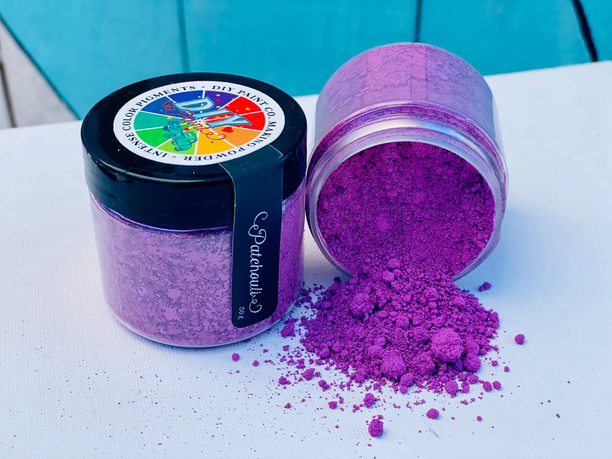 Two jars of Making Powder by DIY Debi’s Design Diary, one open and spilled on a white surface.