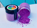 Two jars of Making Powder by DIY Debi’s Design Diary, one open and spilled on a white surface.