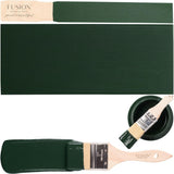 Manor Green Fusion Mineral Paint can with brush and painted wood samples on white background.