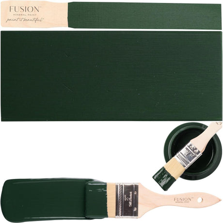 Manor Green Fusion Mineral Paint can with brush and painted wood samples on white background.