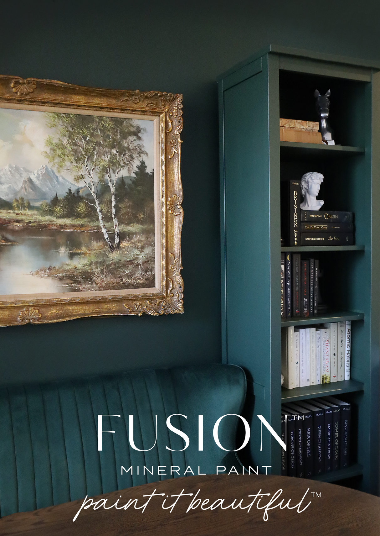 Manor Green Fusion Mineral Paint shown on deep green walls with bookshelf, artwork, and velvet seating.