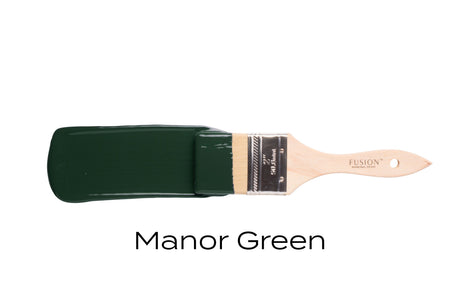 Paintbrush showing Fusion Mineral Paint Manor Green shade on bristles.