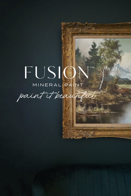 Gold-framed landscape art on wall painted with Fusion Mineral Paint Manor Green and “paint it beautiful” overlay.