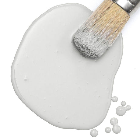 Light-bristled brush on spilled Fusion Marble Milk Paint by Fusion Mineral Paint against a white background.