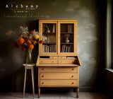 Yellow cabinet painted in Marigold Alchemy by Fusion Mineral Paint, books visible behind glass doors.
