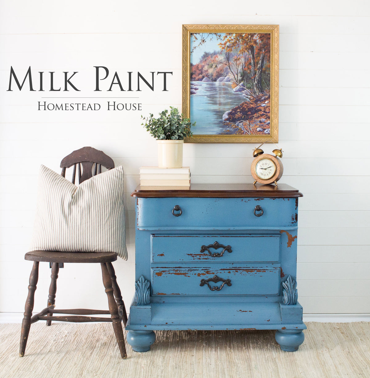 Wooden chair and Maritime Blue Homestead House dresser against a white wall, decor arranged on top of the dresser.