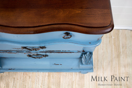 Vintage blue dresser in Homestead House Maritime Blue Milk Paint with ornate metal handles, top view.