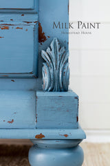 Maritime Blue Milk Paint by Homestead House on ornate furniture corner, text reads “Homestead House”.