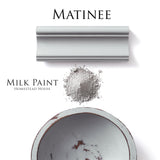 Gray powder pile, painted sample, and Matinee Milk Paint by Homestead House tin demonstrating paint coverage.