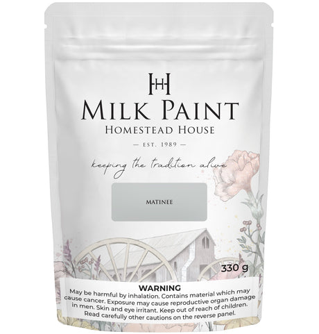 Homestead House Matinee Milk Paint 330g bag with rustic wagon graphic and visible safety warning.