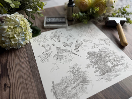I.O.D. Meadowlark Stamp with nature sketch, flowers, ink pad, and Iron Orchid Designs hammer displayed together.