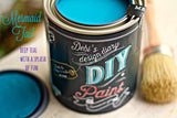 Open can of Mermaid Tale DIY Paint by DIY Paint Co. next to a brush, with text “deep teal with a splash of fun.”.