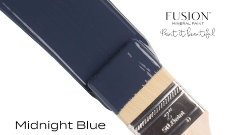 Brush with Midnight Blue Fusion Mineral Paint; text reads “Midnight Blue” and “Fusion Mineral Paint.”.