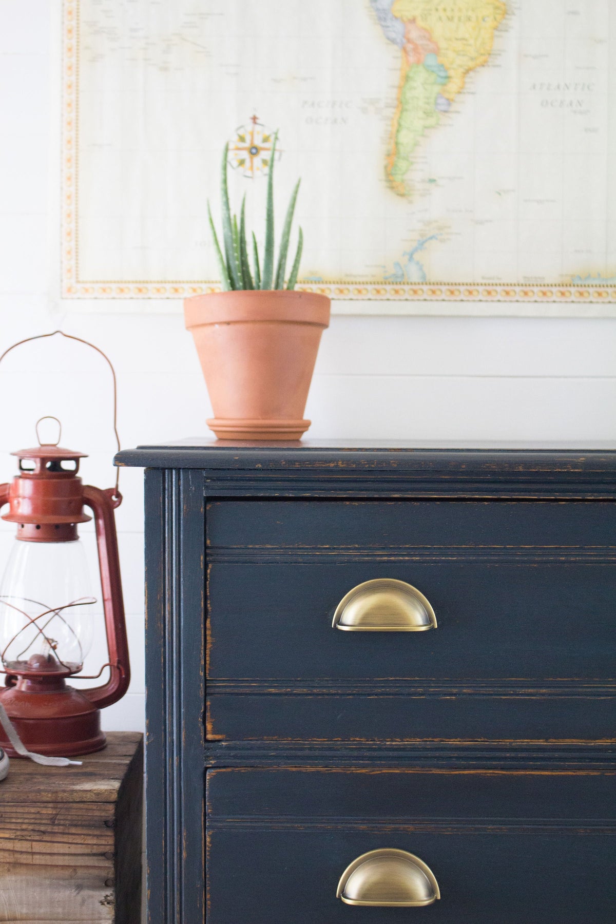 Navy dresser in Homestead House Midnight Blue Milk Paint with brass handles.