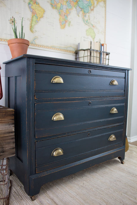 Black dresser with brass handles finished in Homestead House Midnight Blue Milk Paint.