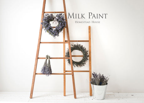 Lavender wreaths beside a white bucket and Fusion Mineral Paint Milk Paint Wood Stain container.