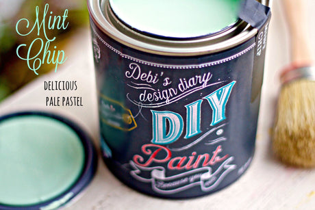 Open can of DIY Paint Co. Mint Chip paint with lid and brush visible.