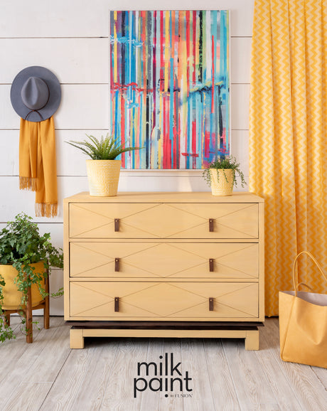 Dresser painted in Mod Mustard Milk Paint by Fusion, styled with decor and plants.