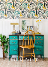 Teal desk painted with Montclair Milk Paint by Homestead House, paired with wood chair and lamp.