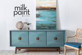 Blue Fusion Mineral Paint Monterey sideboard with three drawers, basket, bird decor, and seascape painting above.