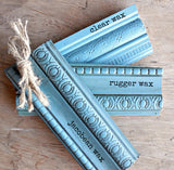 Moody Blue wood samples in clear, Rugger, and Jacobean wax by Old Fashioned Milk Paint on wood surface.