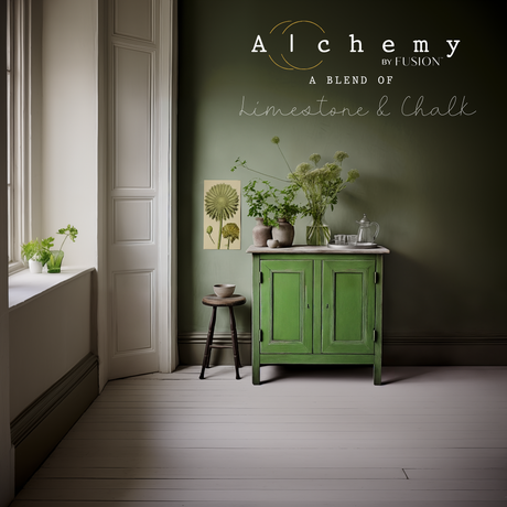Green cabinet against olive wall, painted in Moss Alchemy by Fusion Mineral Paint, with green plants nearby.